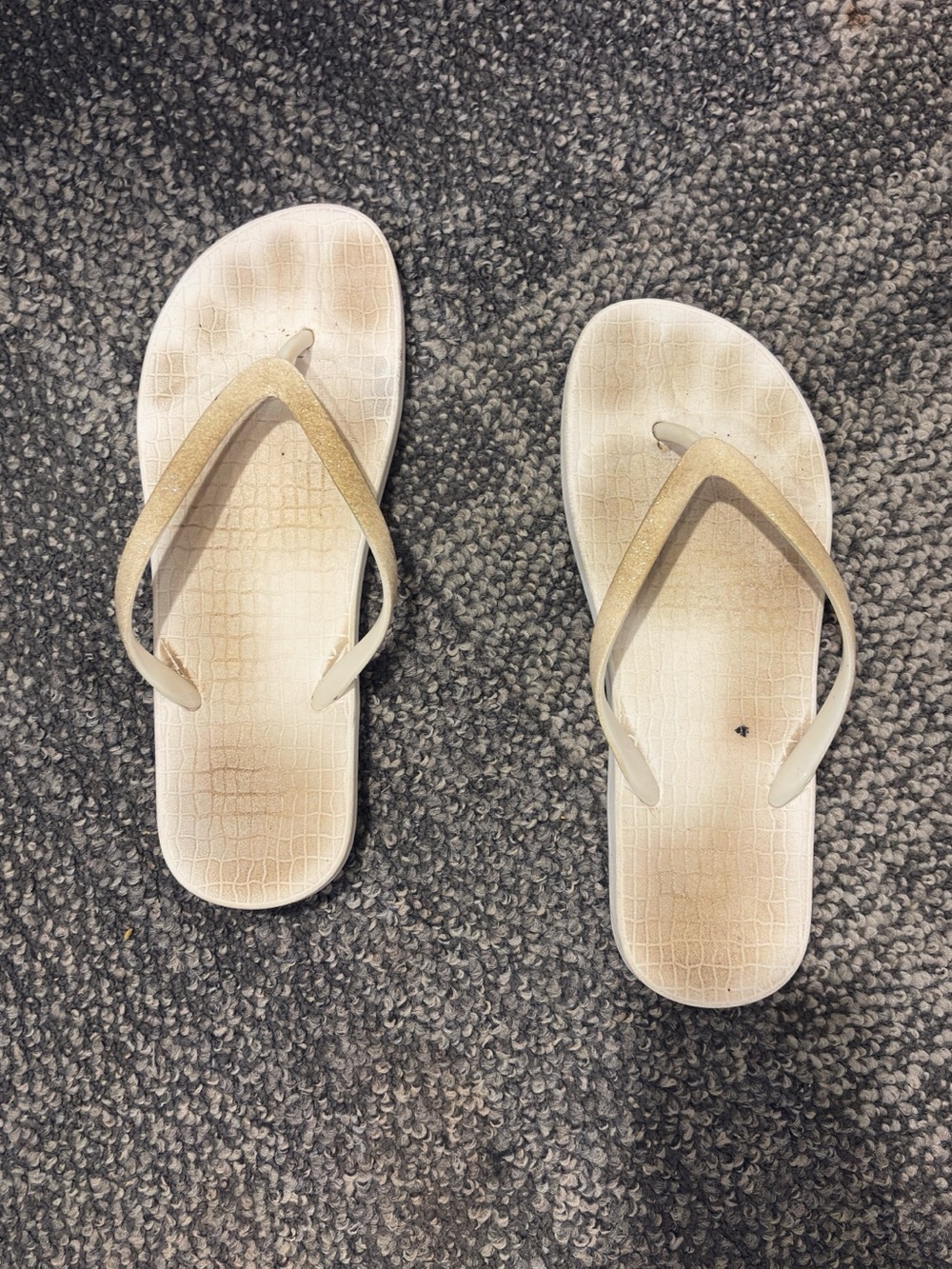 Woman’s white flip flops
